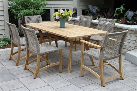 This minimalist dining table blends a resilient aluminum base with a composite wood surface, creating both a mixed material look and a nod to classic outdoor designs. Nautical Teak Hardwood Outdoor Rectangle Dining Table