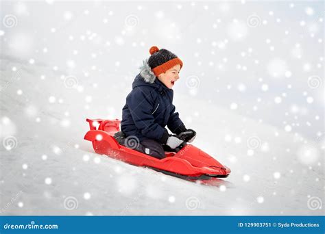 Happy Boy Sliding On Sled Down Snow Hill In Winter Stock Image Image