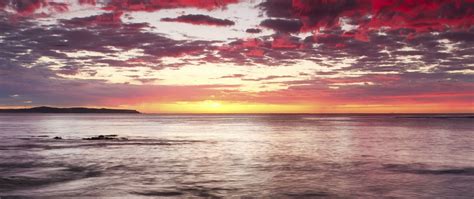 Download Wallpaper 2560x1080 Sunset Horizon Beach Stones Sea Dual