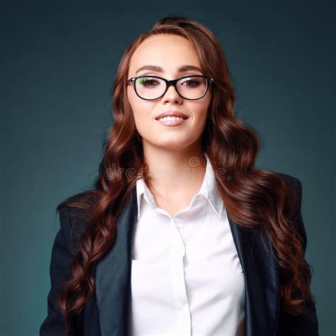 A Beautiful Middle Aged Brunette Woman In Glasses And A Business Suit