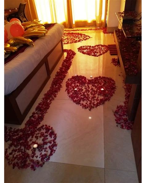 A wedding first night bed with complex floral arrangements sounds awesome fora romantic night for the couple. Romantic Room Decoration with rose petals and candles ...