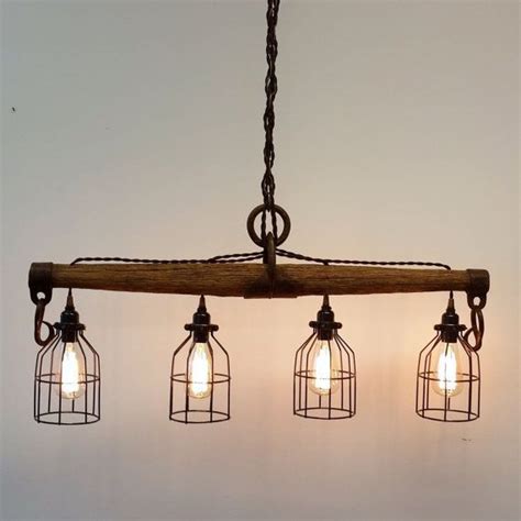 I wanted to create a version of this chandelier that would work outside and not involve electricity. Rustic Industrial Yoke Chandelier by UrbanAnalog on Etsy | Aydinlatmalar, Lamba