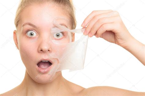Girl Removing Facial Peel Off Mask Stock Photo By ©voyagerix 71791763