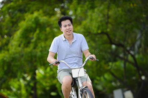 Young Asian Man Riding A Vintage Bicycle In A Park Stock Image Image