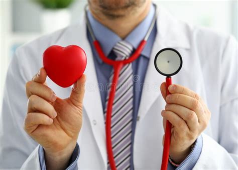Male Medicine Doctor Holding Red Heart And Stethoscope Stock Photo