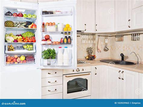Open Refrigerator Filled With Fresh Fruits Vegetables And Milk Stock