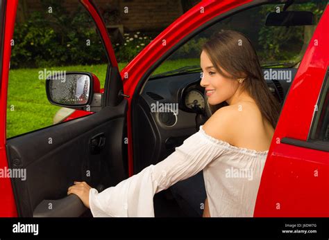 Young Woman Leaving Her Red Car After Work Stock Photo Alamy