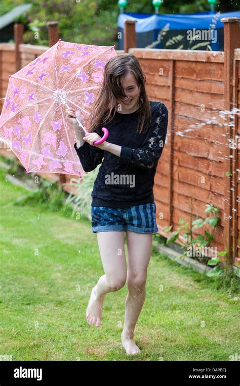 Young Teenager Having A Water Fight In The Garden Stock Photo Alamy