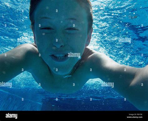 Close Up Portrait Of Boy Swimming Underwater In Swimming Pool Stock