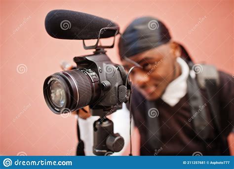 Young Professional African American Videographer Holding Professional