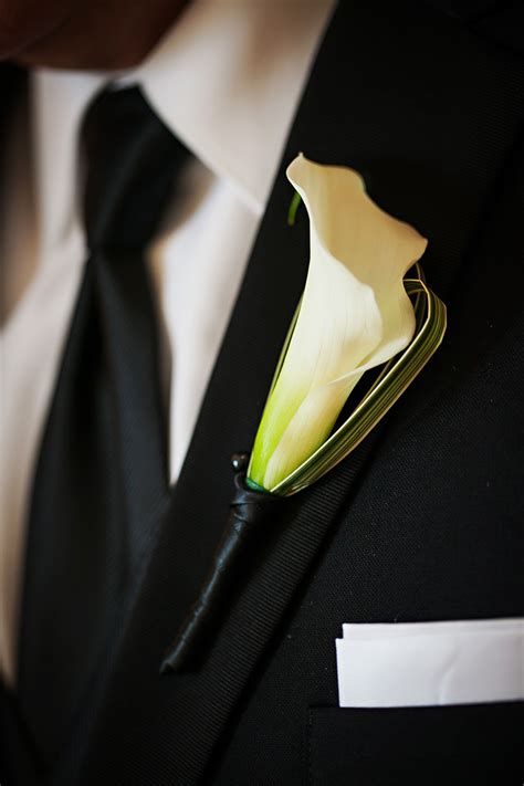 A Classic White Mini Calla Lily Boutonniere With A Touch Of Variegated