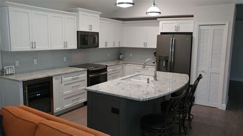 Ge makes these kitchen appliances in both its slate and black slate exteriors. White shaker cabinets with Creekstone island and slate GE ...