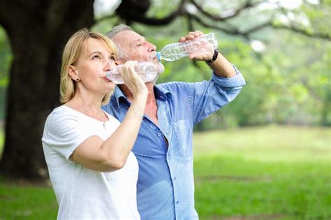 Senior Couple Standing Drinking Water Stock Photo Image Of Exercise