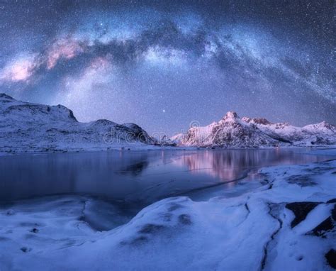 Milky Way Above Frozen Sea Coast And Snow Covered Mountains Stock Photo