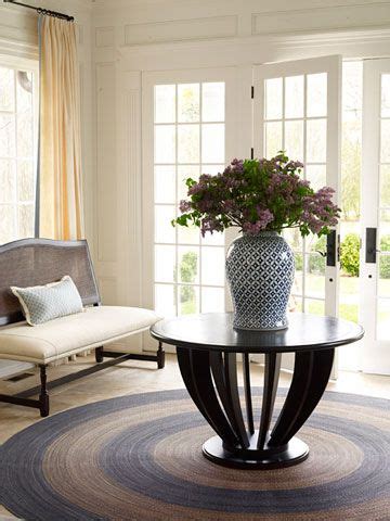 Glass top tables with an interesting wrought iron base is a good choice, since the transparency of the table takes up less esthetic space and shows off your carpet. Relaxed Living | Round foyer table, Foyer table, Entrance ...