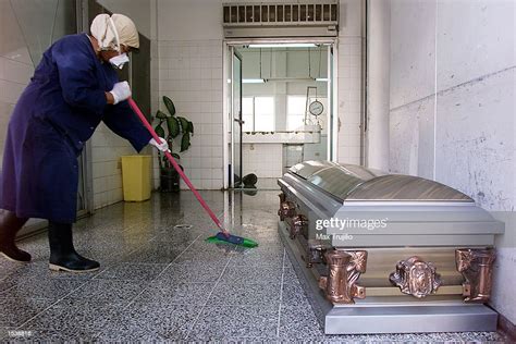 An Employee Of The City Morgue Cleans Around The Coffin Of Singer