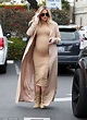 Pregnant Khloe Kardashian shows hint of baby bump in skintight dress ...