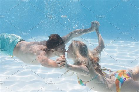 Cute Couple Kissing Underwater In The Swimming Pool High Quality