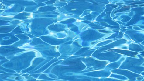 Water Surface Of A Swimming Pool At Night With Light Reflections And A