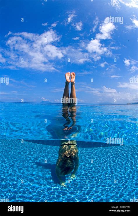 Relaxing In Infinity Pool Wpman Doing An Underwater Handstand Stock
