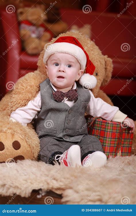 Cute Baby Boy In Santa Hat With Big Teddy Bear And Christmas Ts