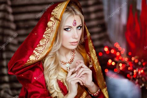 Beautiful And Sensual Blonde Girl In Indian Red Saree And The Ho Stock