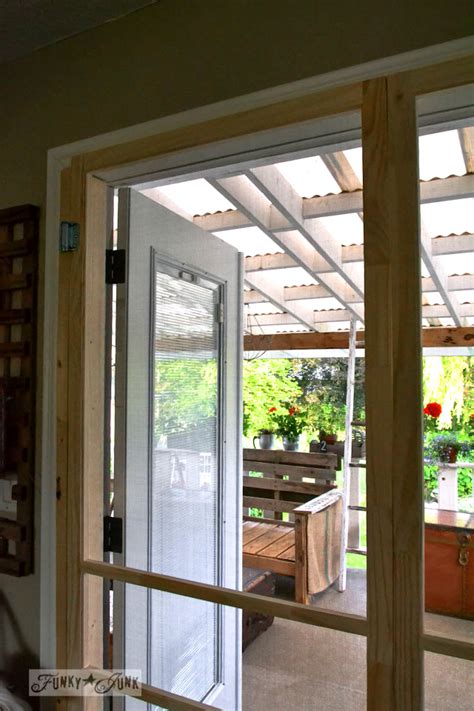 The large glass patio door hasn't been around for very long. Installing screen doors on french doors... easy and cheap!Funky Junk Interiors