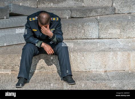 Sad Policeman Is Sitting On The Floor With His Had Down He Lost His