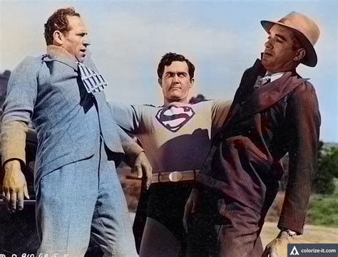 Two Men Dressed As Superman And Another Man In A Suit