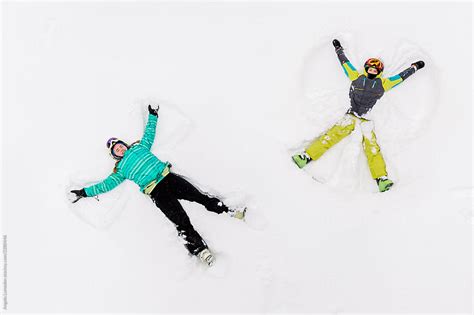 Two Teenage Kids Making Snow Angels In Deep Snow Del Colaborador De