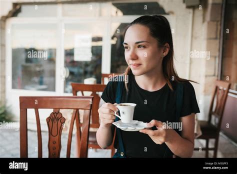 Beautiful Woman Drinking Coffee At The Cafe Stock Photo Alamy