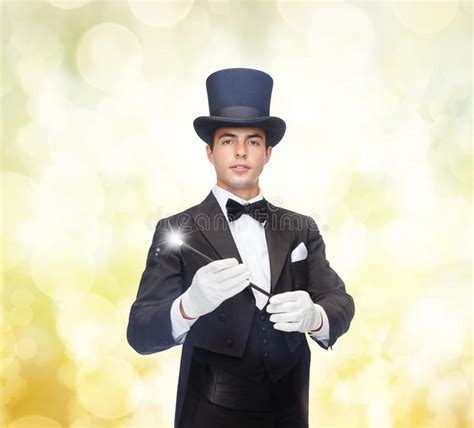 Magician In Top Hat With Magic Wand Showing Trick Stock