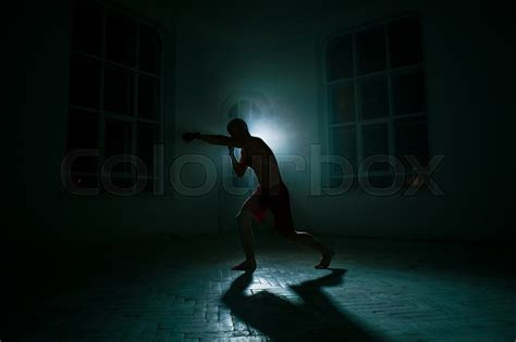 The Young Male Athlete Kickboxing On A Stock Photo