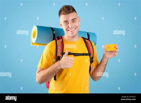 Travel budget. Cool millennial guy with backpack and credit card