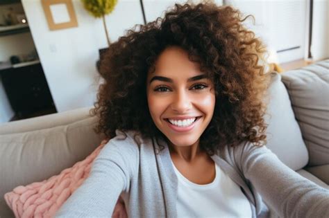 Premium Ai Image Smiling Girl Taking Selfie Picture With Smartphone Lying On The Couch