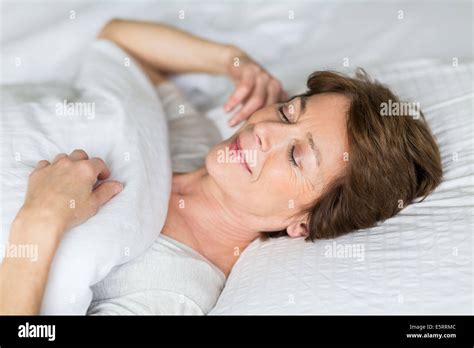 Woman Sleeping In Bed Stock Photo Alamy