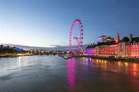 The London Eye Lit Up Pink During Blue Hour And River Thames London