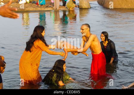 Activities At Tungabhadra River People Bathing In The River Early In