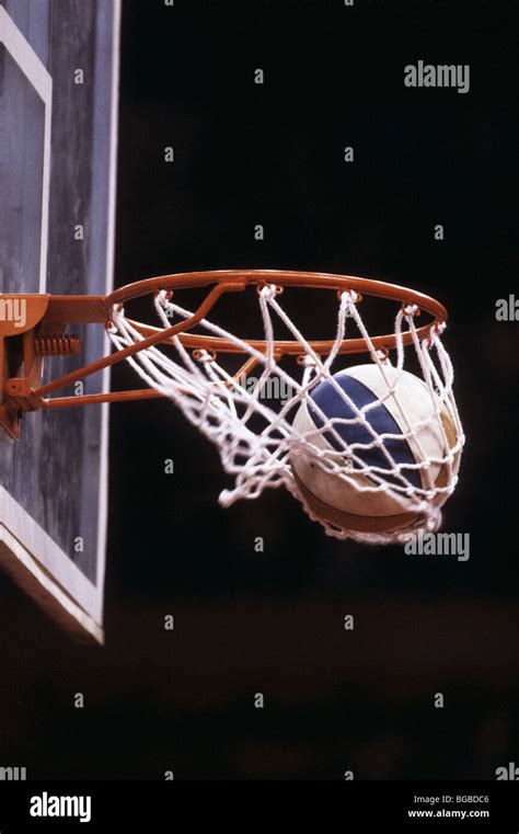 Basketball Going Through A Hoop Stock Photo Alamy