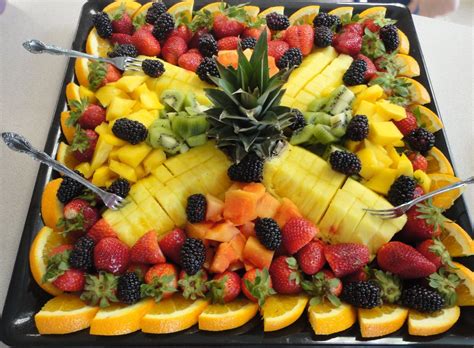 A Platter Filled With Sliced Fruit And Topped With Pineapples Bananas