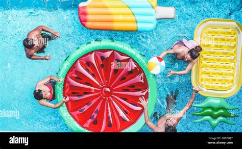 Happy Friends Playing With Air Lilo Ball Inside Swimming Pool Young