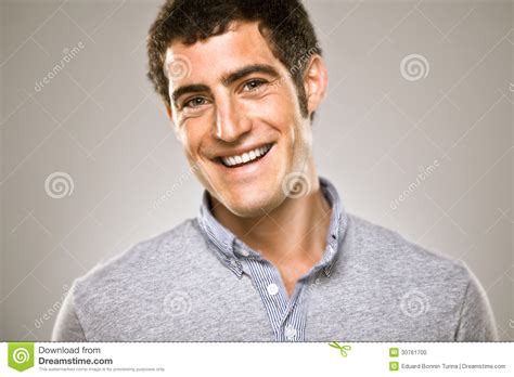 Portrait Of A Normal Boy Over Grey Background Sniling Stock Photo