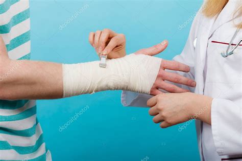 Doctor Bandaging Sprained Wrist — Stock Photo © Anetlanda 184283608