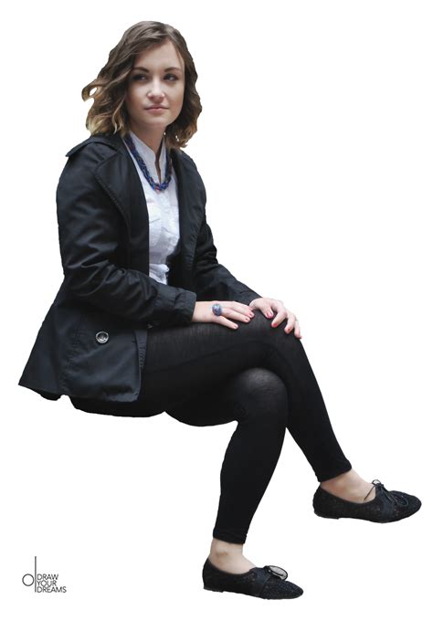 A Woman Sitting On Top Of A White Floor Wearing Black Pants And A Blazer
