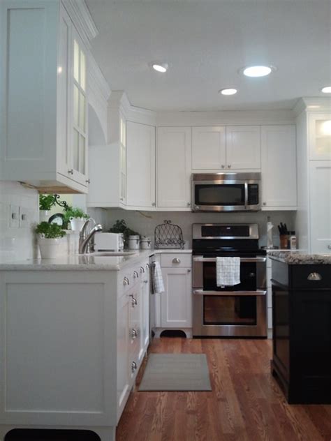 Providing a neutral backdrop, white kitchen cabinets can be left alone or dressed up with colorful art and accessories. White Painted Traditional Mission Style Cabinets