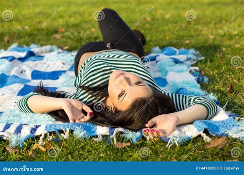 Young Woman Laying Down On The Ground In Autumn Stock Photo Image