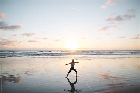 Vibrant Mature Woman Enjoying Herself On The Beach At Sunset By Stocksy Contributor Rob And