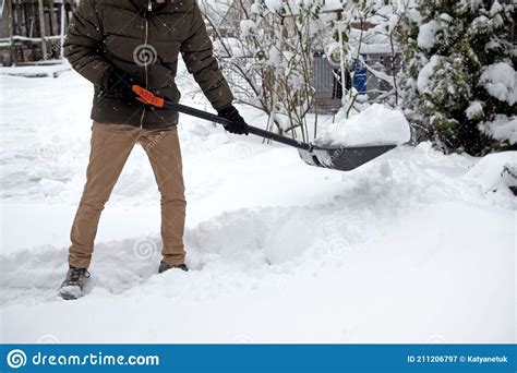 Man With Snow Shovel Cleans Sidewalks In Winter Stock Image Image Of