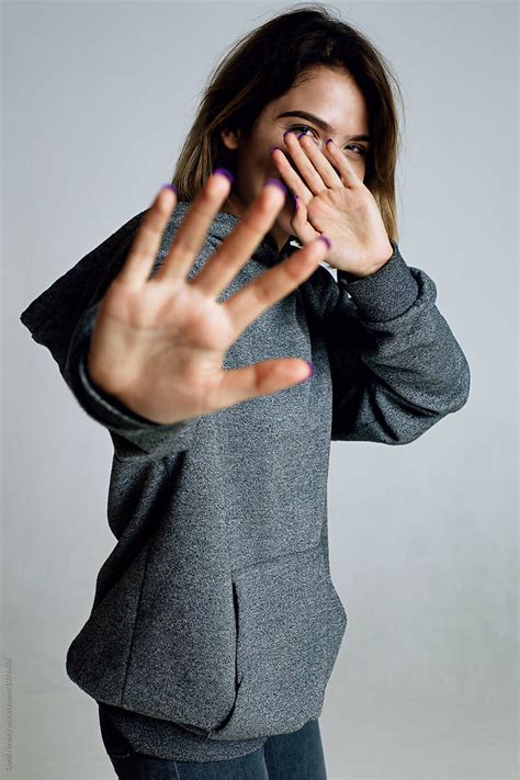 Teen Girl Hiding Face With Palm Hand From Camera By Stocksy Contributor Danil Nevsky Stocksy