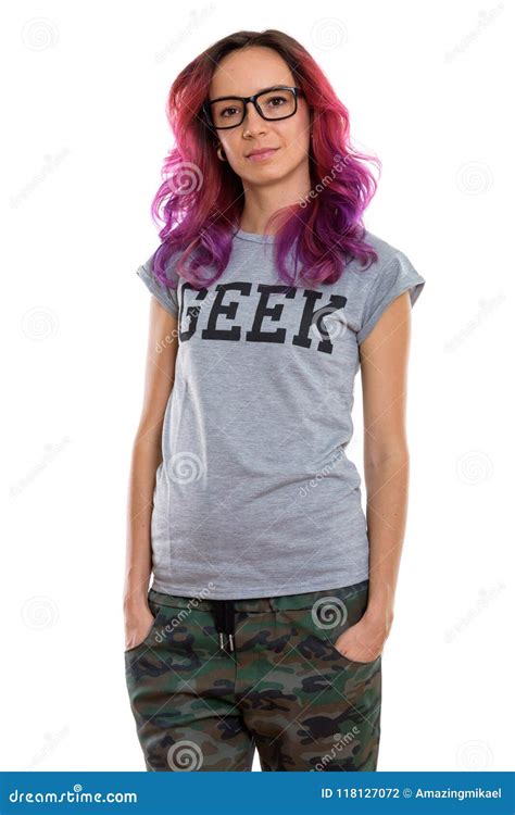 Studio Shot Of Geek Girl Standing While Wearing Eyeglasses Stock Photo